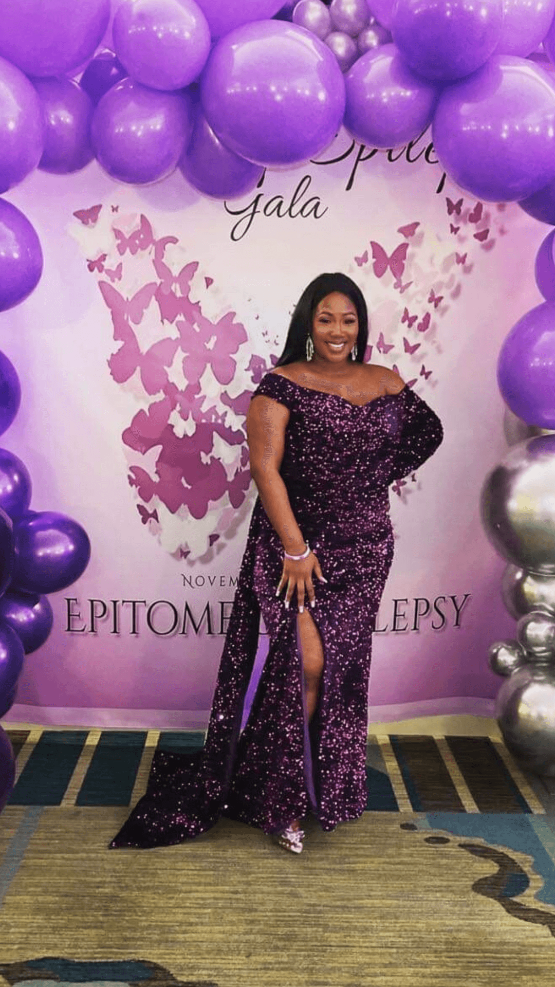 Founder JenVon Cherry at the Jewels of Epilepsy Gala, surrounded by purple balloons